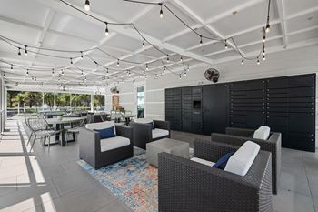 A patio with black furniture and a white ceiling.